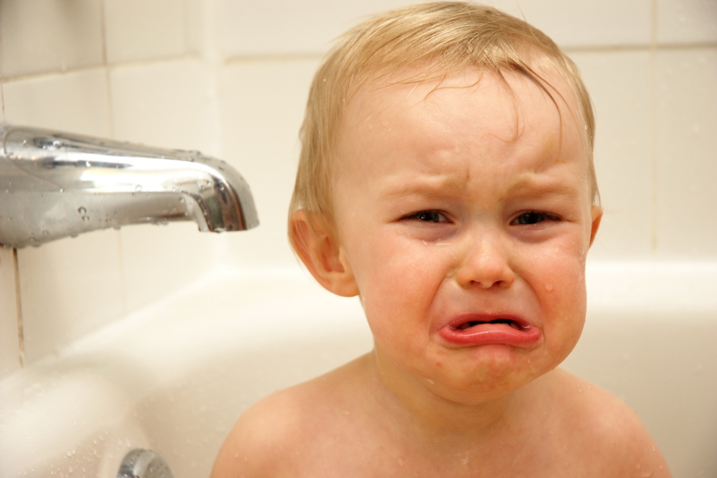Photo of baby crying in bathtub